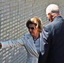 Queen Sonja reads the names of some of the 9 000 victims of Argentina's 1976-1983 military regime listed on the wall in the Parque de la Memoria. Photo: Heiko Junge, NTB scanpix